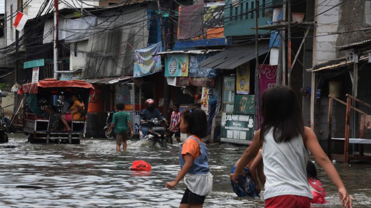 Arsip Foto - Sejumlah anak bermain saat banjir rob melanda kawasan pemukiman Muara Angke, Penjaringan, Jakarta Utara. Jumat (25/11/2022). Badan Meteorologi Klimatologi dan Geofisika (BMKG) merilis sembilan wilayah pesisir DKI Jakarta berpotensi terkena banjir rob yang diperkirakan terjadi pada 22-28 November 2022, diantaranya kawasan Kamal Muara, Kapuk Muara, Penjaringan, Pluit, Ancol, Kamal, Marunda, Cilincing dan Kalibaru. ANTARA FOTO/Indrianto Eko Suwarso/foc.