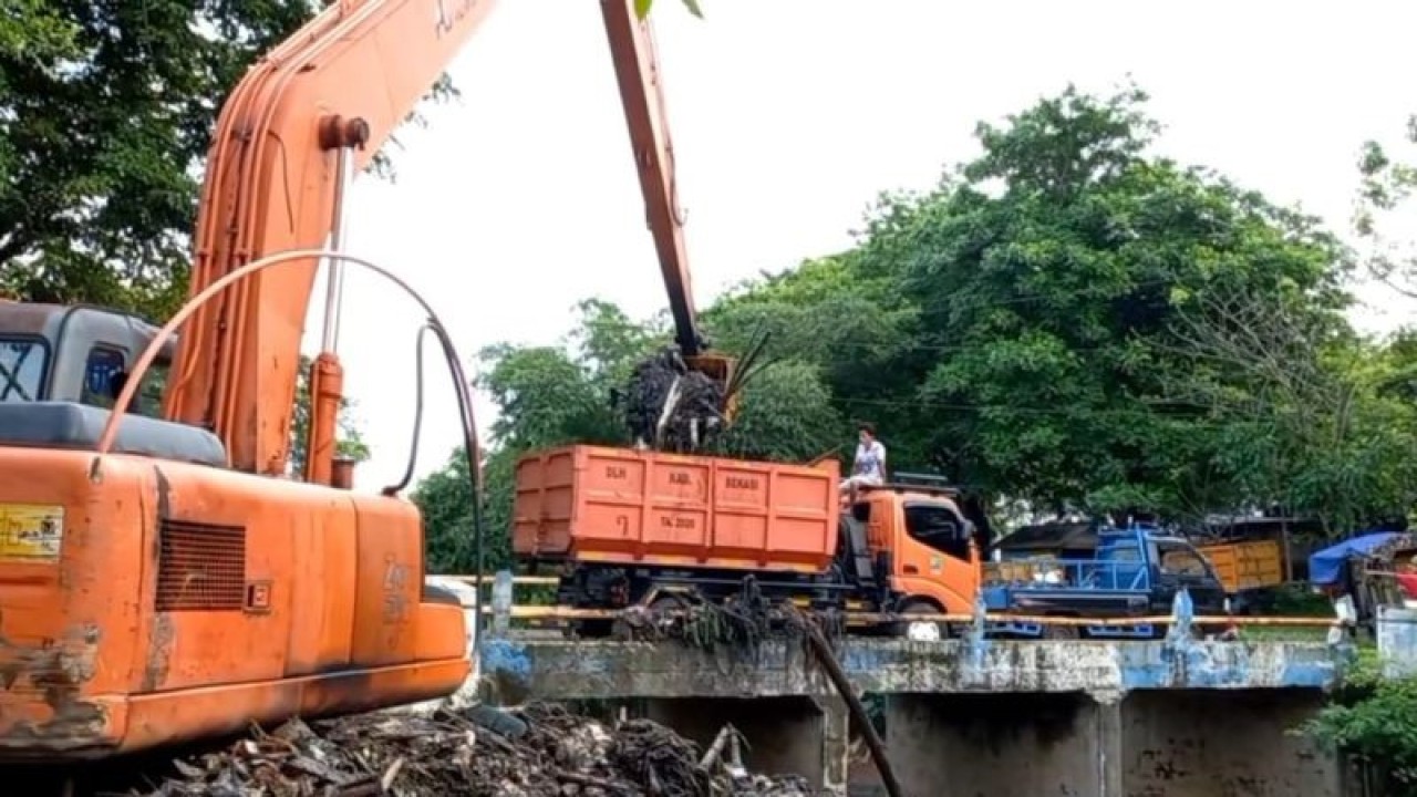 Proses pengangkutan sampah yang menyumbat aliran sungai di Kali Jambe, Kampung Keramat Mundu, Desa Satria Jaya, Kecamatan Tambun Utara, Kabupaten Bekasi, Ahad (11/12/2022). (FOTO ANTARA/Pradita Kurniawan Syah).
