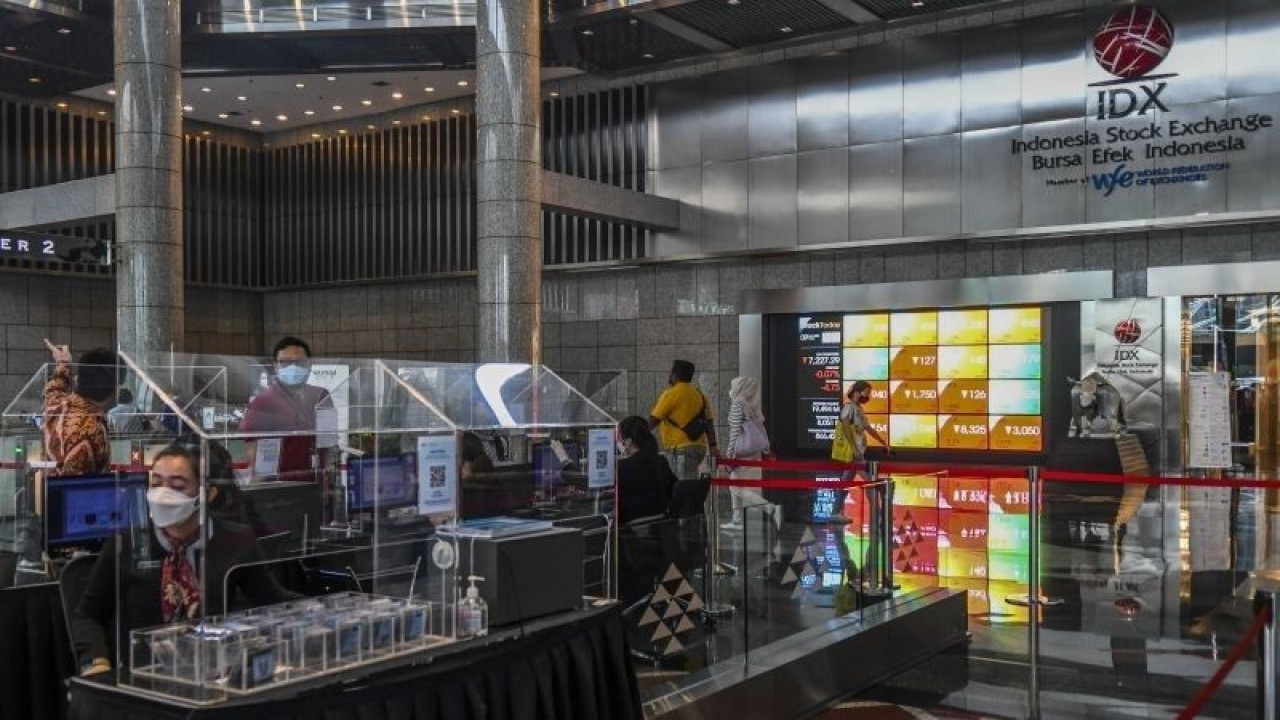 Karyawan melintas di samping layar elektronik yang menunjukkan pergerakan Indeks Harga Saham Gabungan (IHSG) di Bursa Efek Indonesia, Jakarta, Jumat (9/9/2022). ANTARA FOTO/Galih Pradipta/aww.
