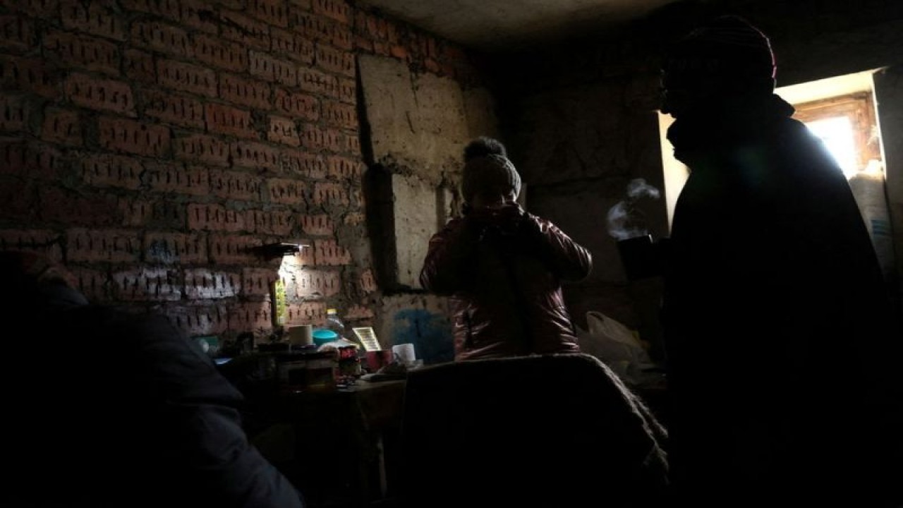 Arsip - Lilia (44) dan Olexii (42) menyesap teh panas dalam cahaya redup di ruang bawah tanah sebuah gedung apartemen tempat mereka tinggal tanpa listrik, air, atau pemanas, setelah bangunan tempat mereka tinggal dibom seminggu lalu, ketika invasi Rusia di Ukraina berlanjut, di Siversk, Ukraina, 4 Desember 2022. (ANTARA/REUTERS/Leah Millis/as)