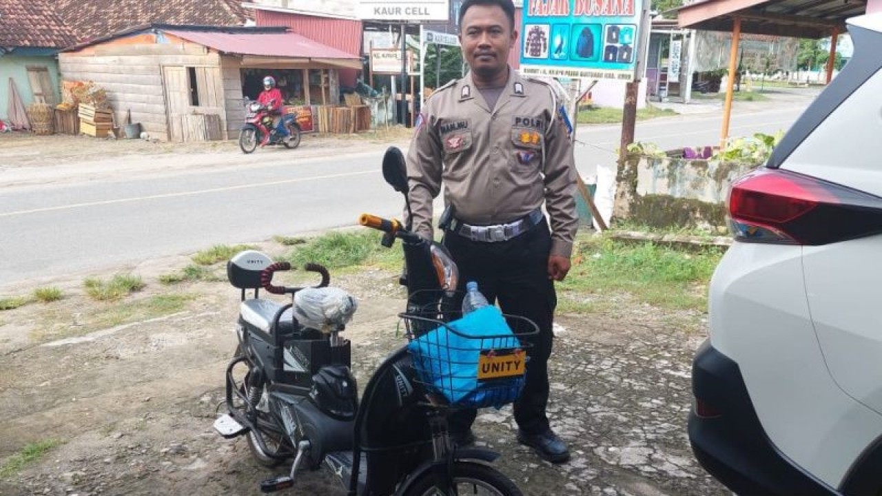 Salah satu anggota Lantas Polres Kaur saat menilang sepeda listrik yang digunakan di jalan raya. ANTARA/Anggi Mayasari.