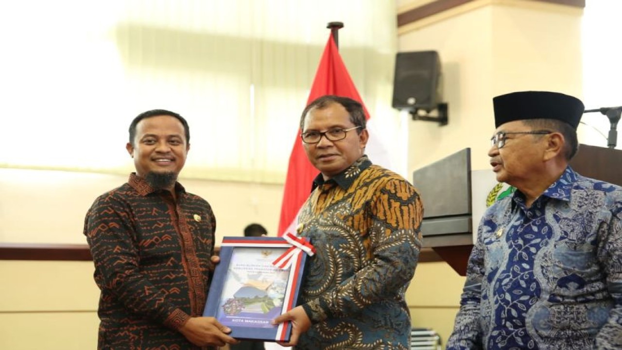Wali Kota Makassar Moh Ramdhan Pomanto (tengah) saat menerima plakat penghargaan dari Menkeu yang diserahkan Gubernur Sulsel Andi Sudirman Sulaiman. ANTARA/HO/Pemkot Makassar