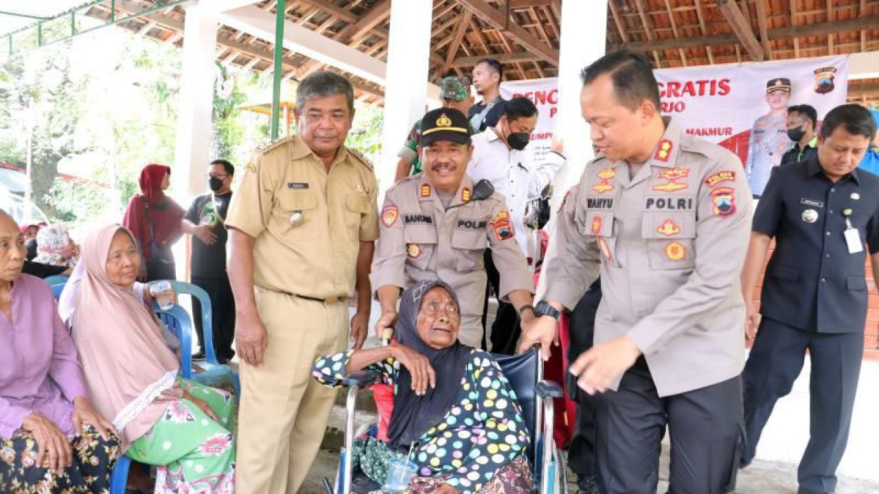 Kepala Polres Sukoharjo AKBP Wahyu Nugroho Setyawan (kanan) saat membantu dorong kursi roda seorang nenek usai ikuti pengobatan gratis di Desa Gentan, Kecamatan Bulu, Kabupaten Sukoharjo, Selasa (24/1/2023) ANTARA/Bambang Dwi Marwoto