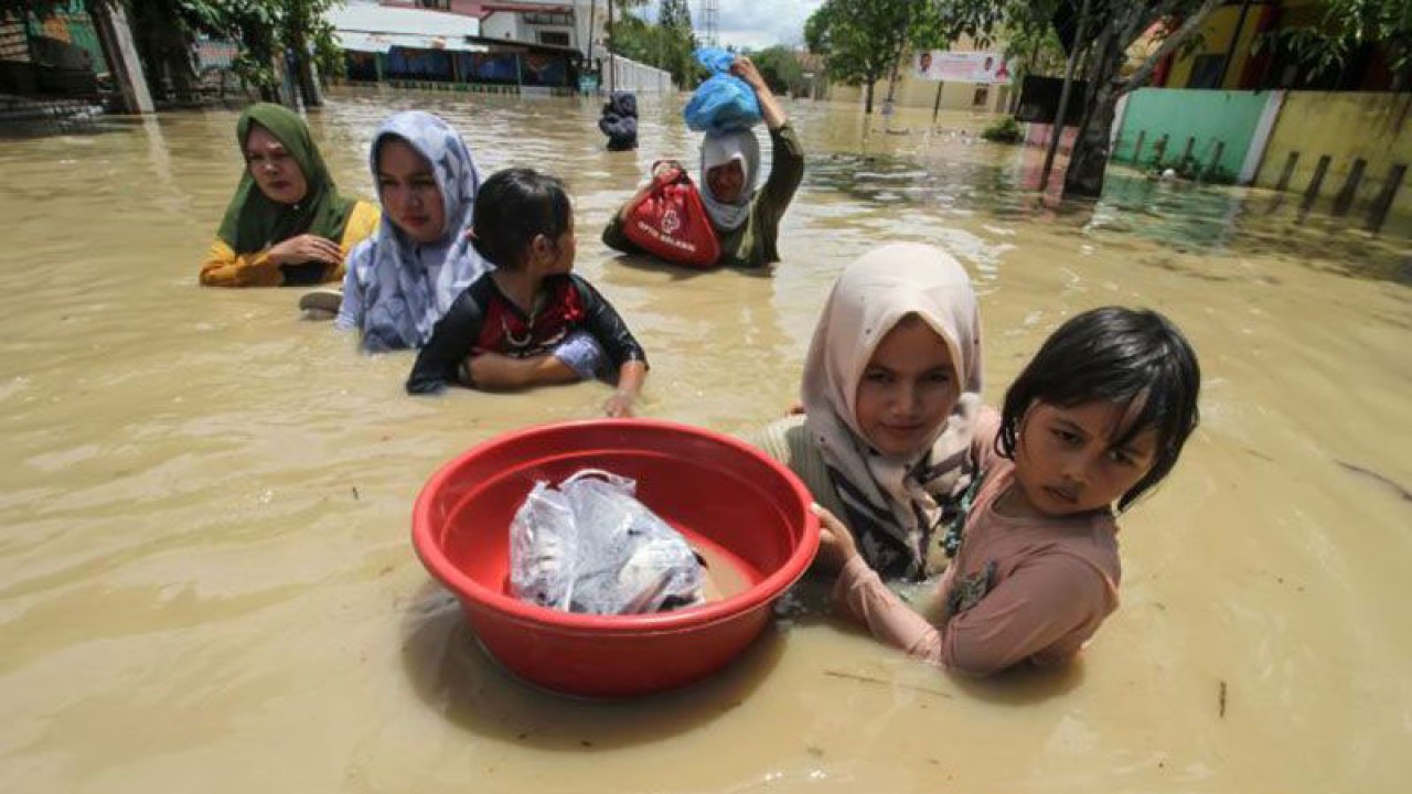 Dokumentasi - Warga melintasi banjir di Lhoksukon, Aceh Utara, Aceh, Kamis (6/10/2022). ANTARA/Rahmad