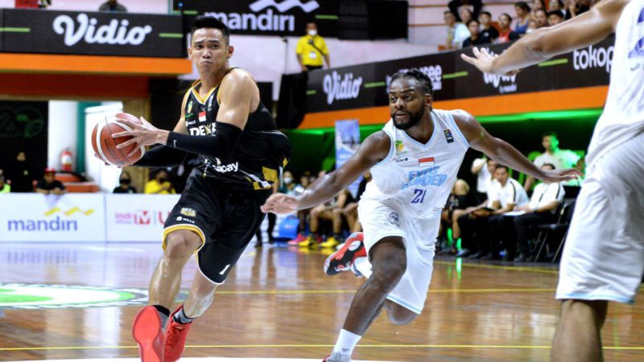 Pebasket Dewa United Banten Azzaryan Pradhitya (kiri) berusaha melewati pebasket Evos Thunder Bogor David Haye (kanan) saat pertandingan Indonesian Basketball League (IBL) 2023 di GOR Merpati, Denpasar, Bali, Senin (16/1/2023). . ANTARA FOTO/Fikri Yusuf/rwa. (ANTARA FOTO/FIKRI YUSUF)