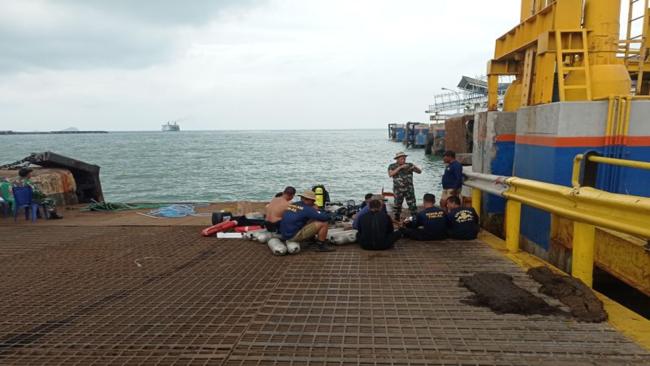 Tim penyelam beristirahat setelah melakukan evakuasi pengangkatan truk pengangkut semen yang jatuh ke laut di Dermaga 5 Pelabuhan Merak, Banten. ANTARA/Mansur