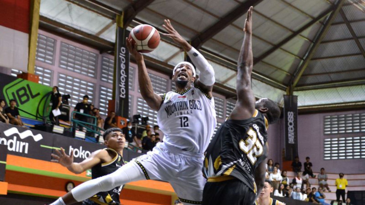 Pebasket Mountain Gold Timika Jarrid Jerome Famous (kiri) berusaha memasukkan bola dihadang pebasket Dewa United Banten Anthony Johnson (kanan) saat pertandingan Indonesian Basketball League (IBL) 2023 di GOR Merpati, Denpasar, Bali, Sabtu (14/1/2023). Dewa United Banten berhasil mengalahkan Mountain Gold Timika dengan skor 76-64. ANTARA FOTO/Fikri Yusuf/foc.