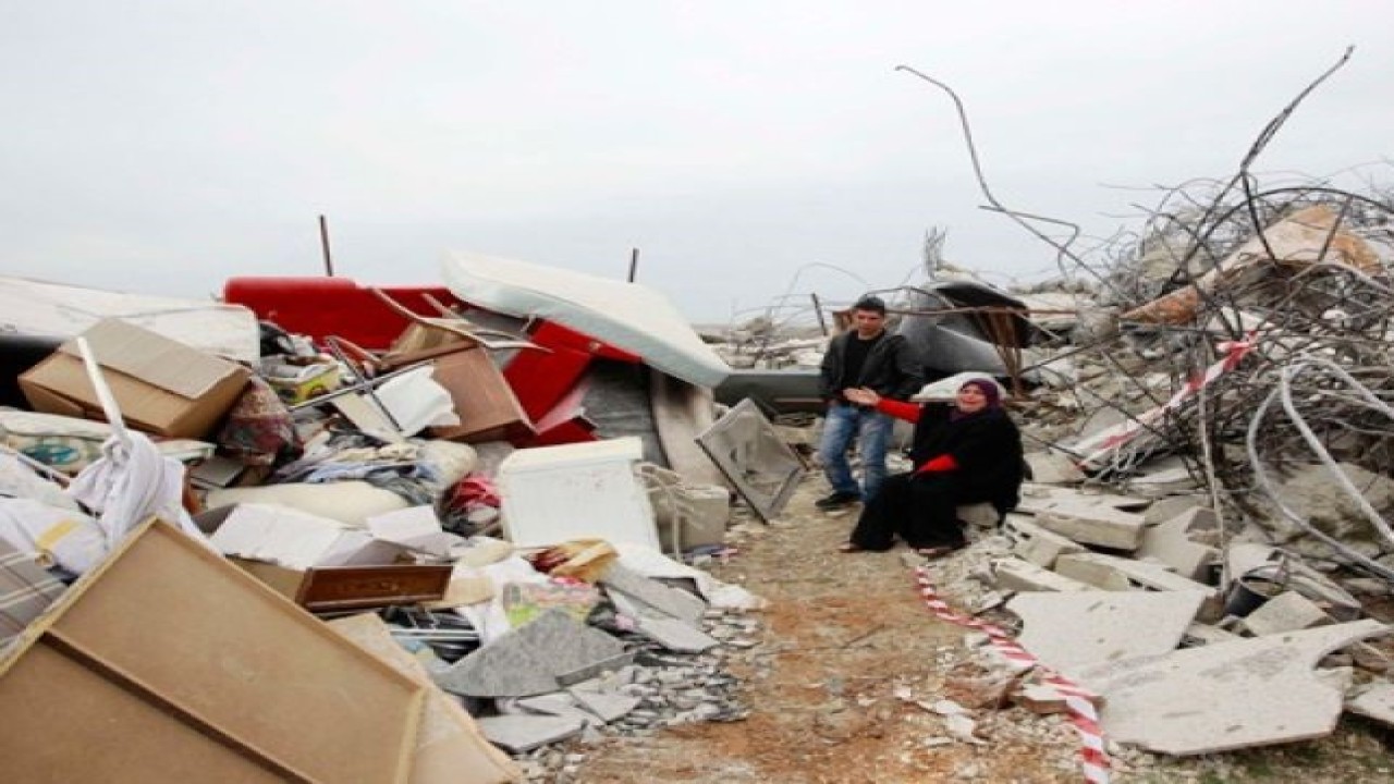 Seorang perempuan Palestina duduk di tengah reruntuhan rumahnya yang dihancurkan di pemukiman Beit Hanina, Yerusalem Timur, Selasa (5/2). Kotamadya Yerusalem mengatakan bahwa ada perintah pengadilan untuk membongkar rumah tersebut, yang dibangun tanpa izin di sebuah area terbuka yang melarang pendirian bangunan. (REUTERS/Ammar Awad)