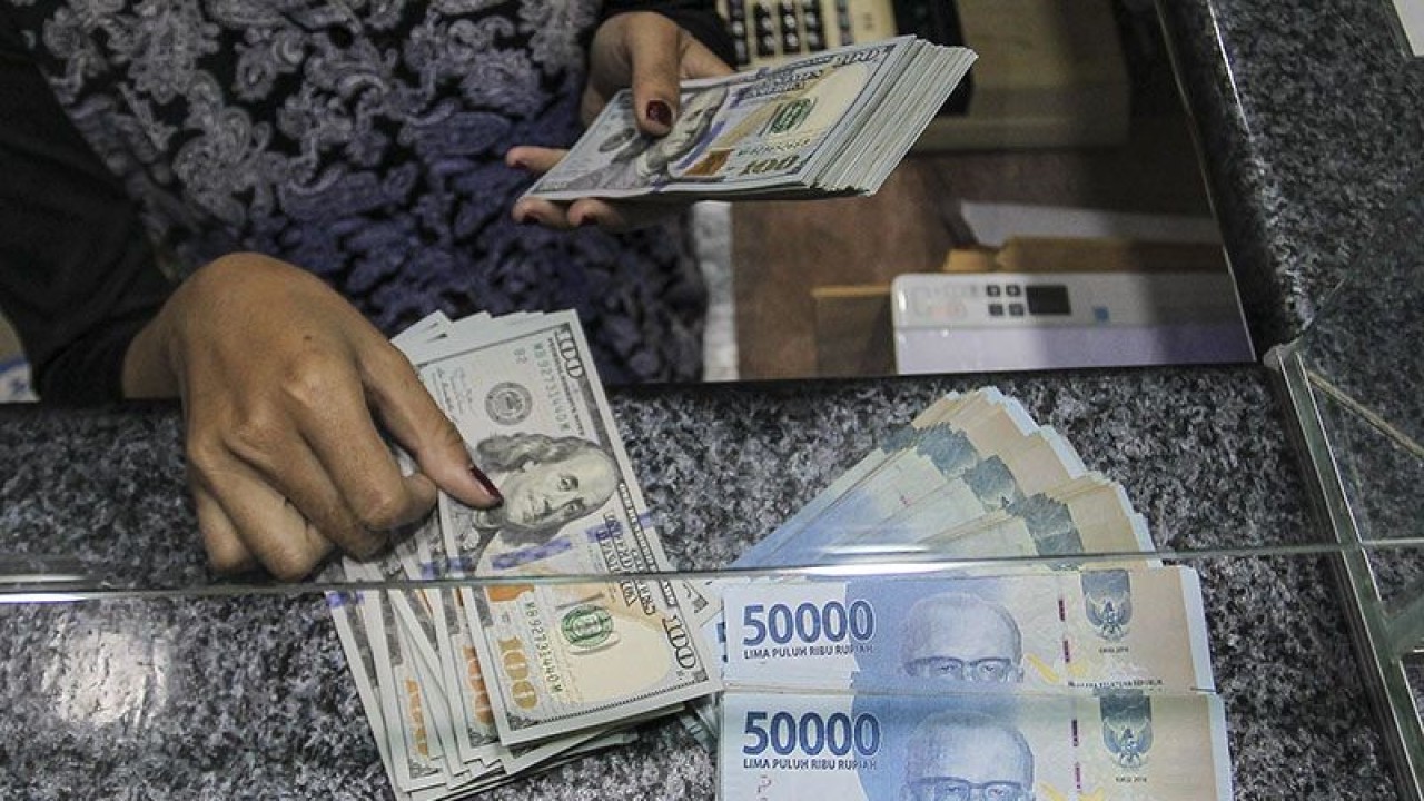 Pekerja menghitung uang dolar AS di salah satu gerai penukaran mata uang di Jakarta. ANTARA FOTO/Dhemas Reviyanto/wsj.