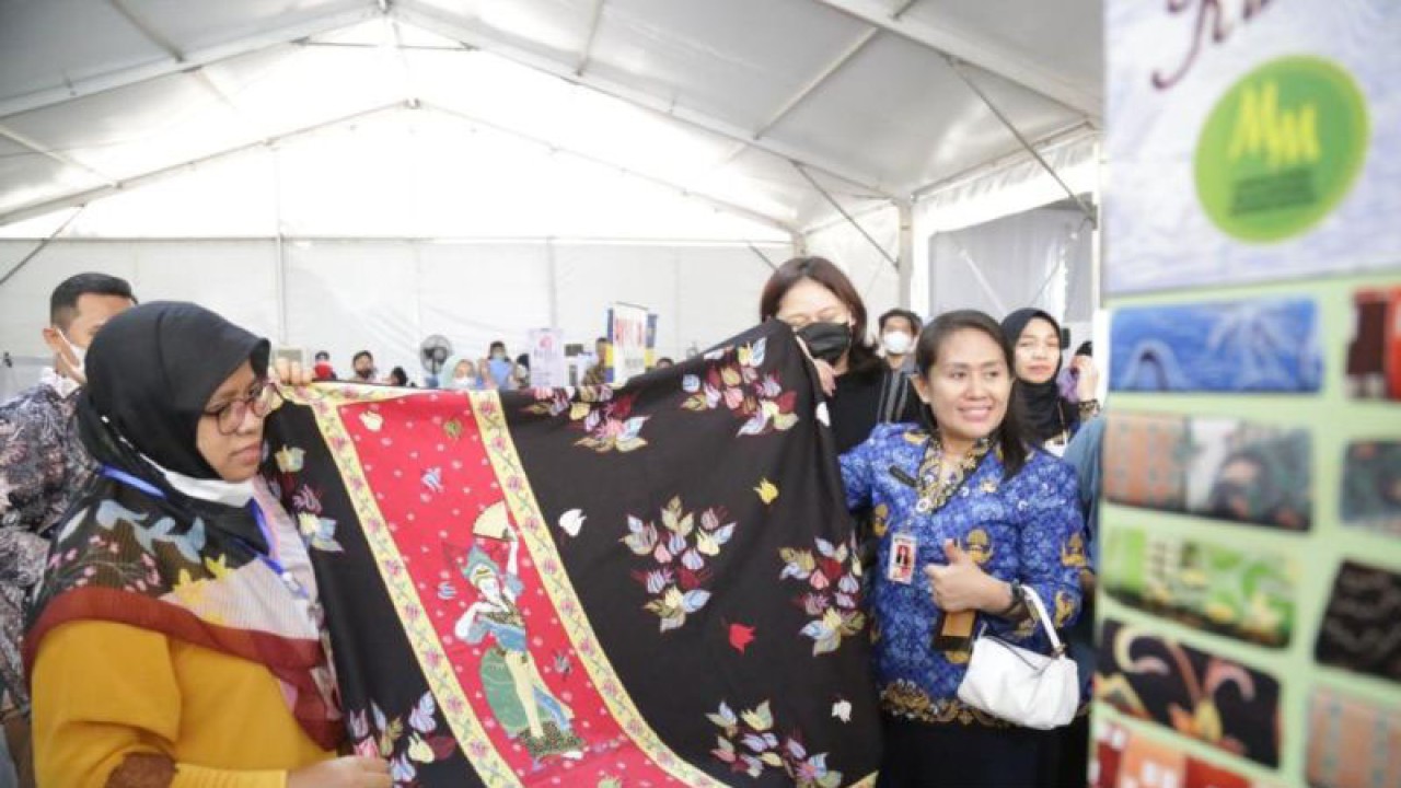 Kepala Dinas Perindustrian, Perdagangan, Koperasi, Usaha Kecil dan Menengah (PPKUKM) DKI Elisabeth Ratu Rante Allo (kanan) menunjukkan batik Betawi dalam salah satu pameran di Jakarta, Senin (30/1/2023). ANTARA/Dewa Ketut Sudiarta Wiguna