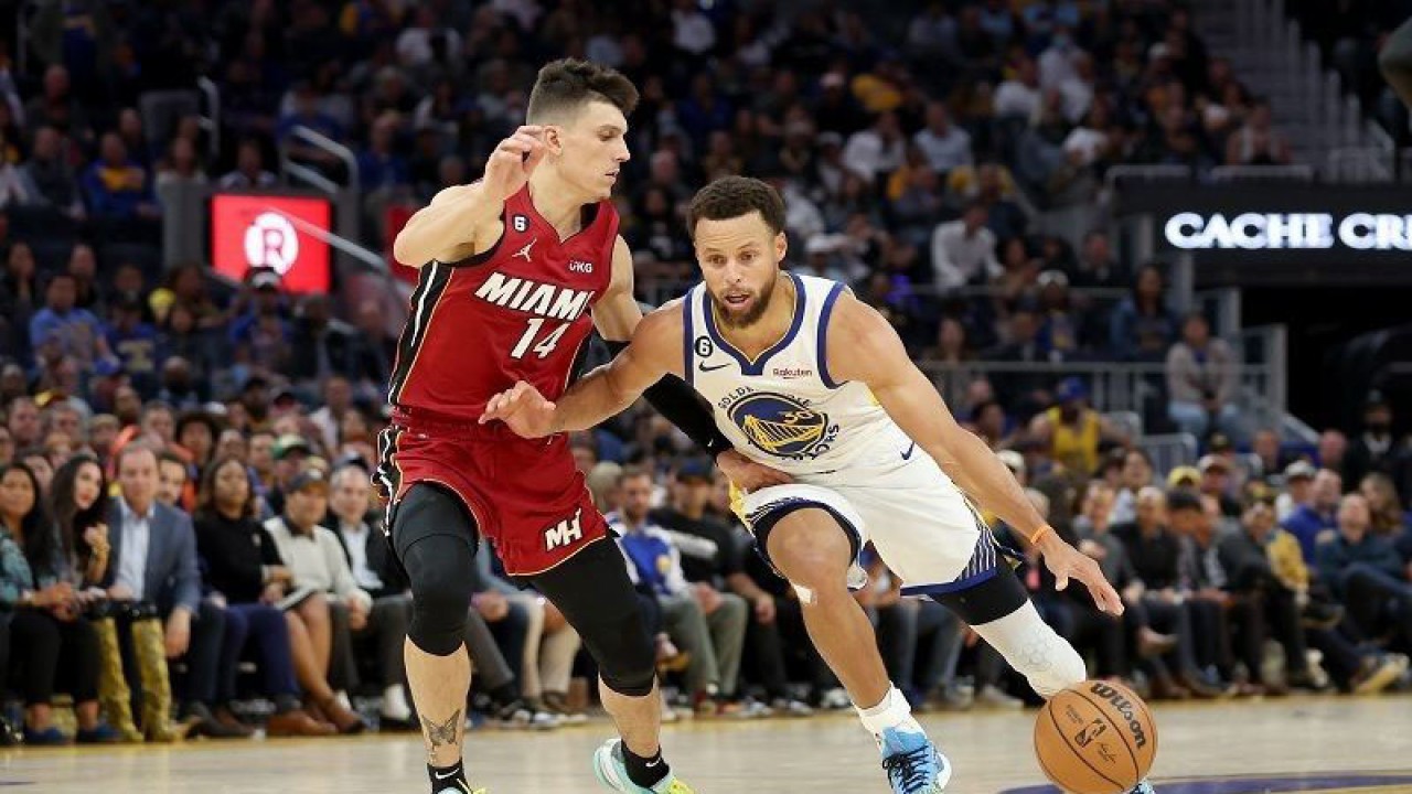 Bintang Golden State Warriors Stephen Curry (kanan) berusaha mengecoh pemain Miami Heat Tyler Herro dalam lanjutan NBA di Chase Center, California, Amerika Serikat, Kamis (27/10/2022) waktu setempat. (ANTARA/AFP/GETTY IMAGES/Ezra Shaw)