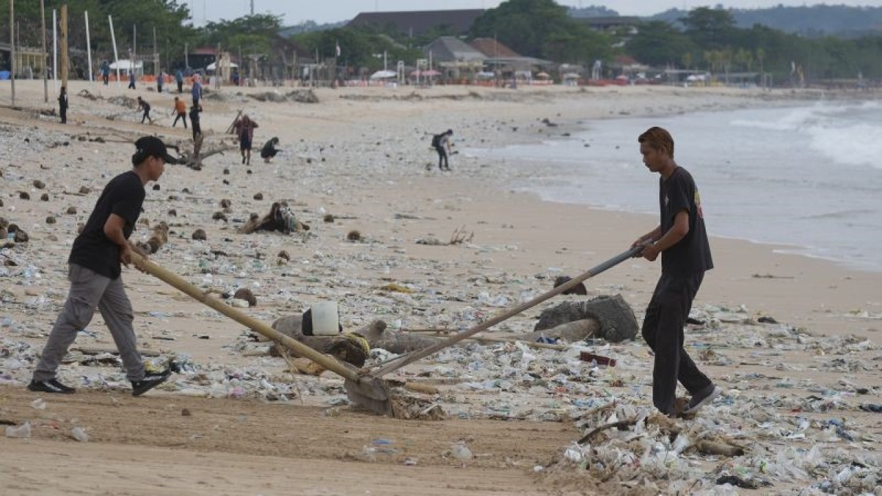Ilustrasi - Sejumlah pekerja membersihkan sampah terdampar akibat cuaca ekstrem di Pantai Kedonganan, Badung, Bali, Kamis (9/2/2023). ANTARA FOTO/Nyoman Hendra Wibowo/nym/aa.