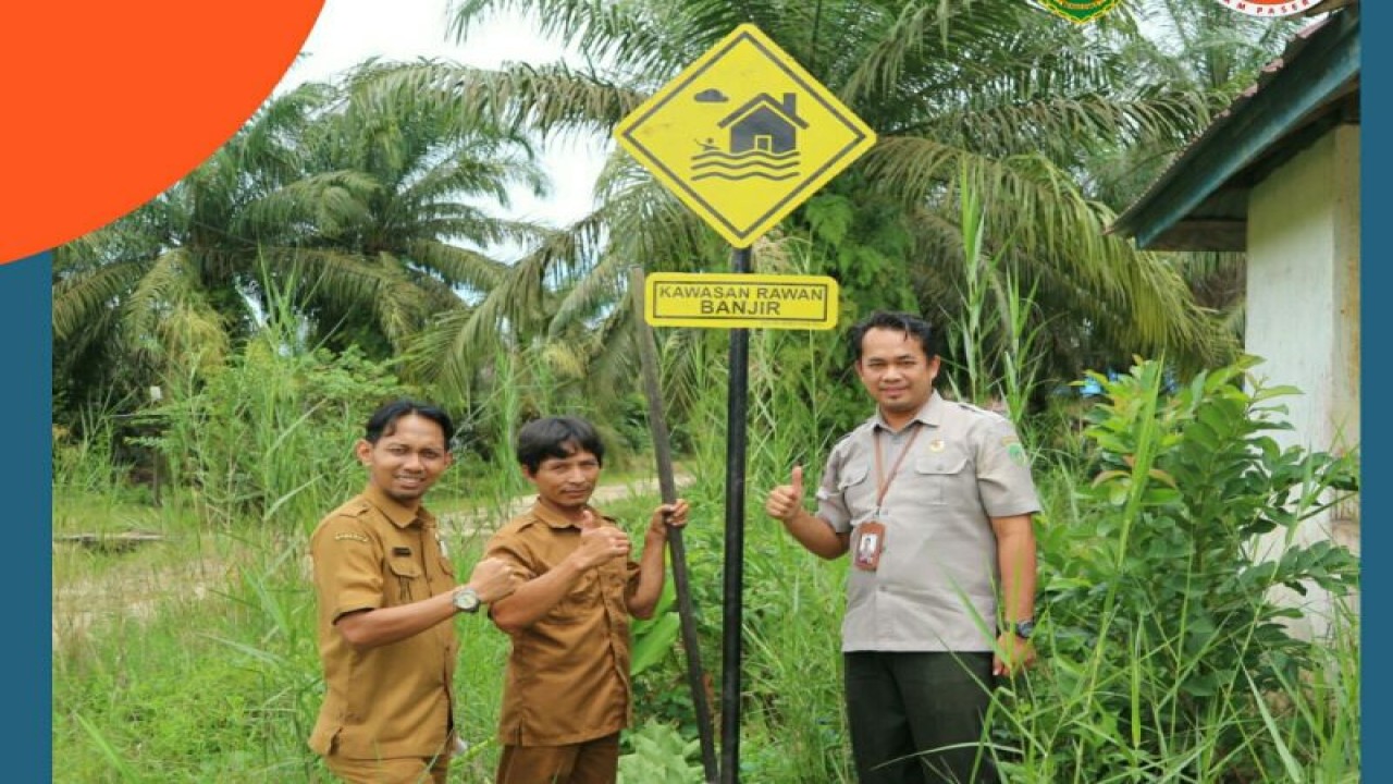 Pegawai BPBD Kabupaten PPU berfoto setelah memasang rambu rawan banjir di Kelurahan Lawe-Lawe, Kecamatan Penajam, Kabupaten PPU, Rabu (22/2) (Antara /HO BPBD Kabupaten PPU)