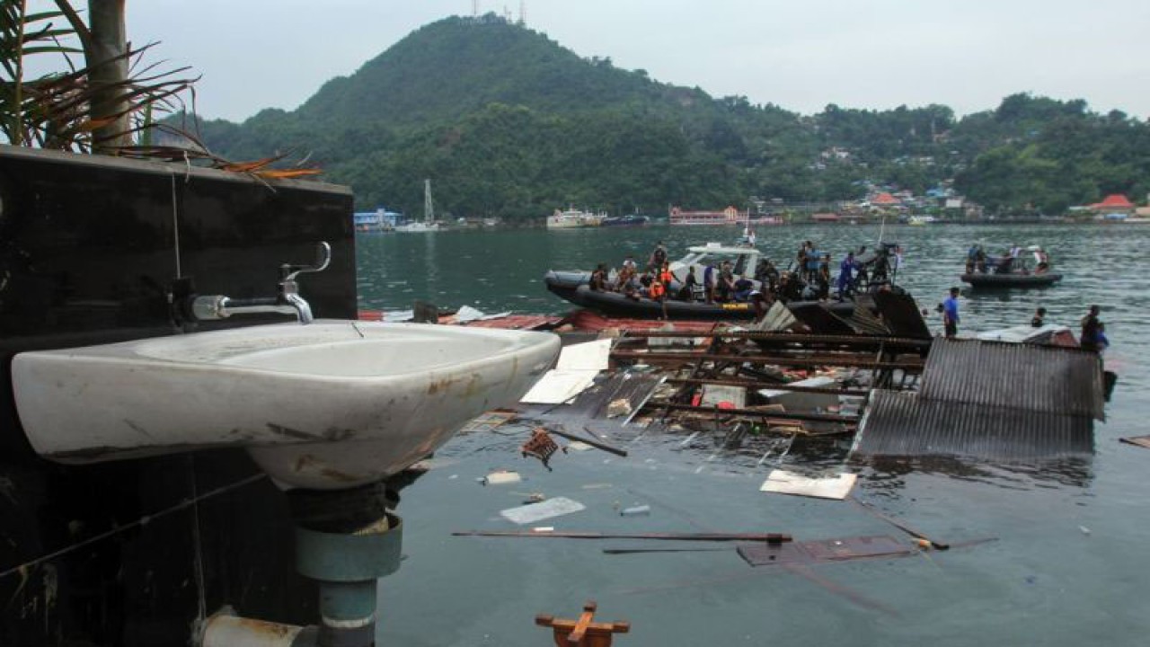 Sejumlah polisi mencari korban di reruntuhan bangunan restoran yang tenggelam akibat gempa di Jayapura, Papua, Kamis (9/2/2023). Badan Nasional Penanggulangan Bencana (BNPB) melaporkan empat orang meninggal dunia dan sejumlah bangunan rusak akibat gempa berkekuatan 5,4 SR tersebut. ANTARA FOTO/Gusti Tanati/tom.