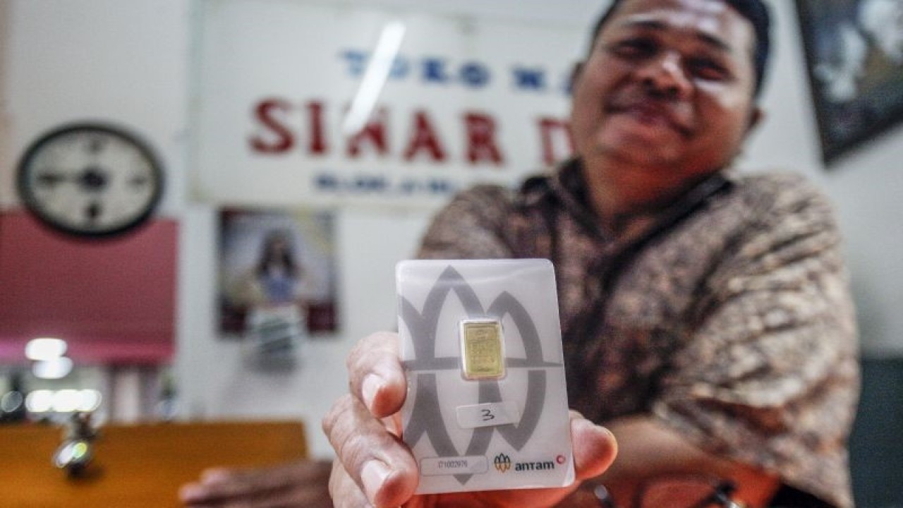Pedagang menunjukkan produk emas PT Antam di Cibinong, Kabupaten Bogor, Jawa Barat, Senin (20/2/2023). ANTARA FOTO/Yulius Satria Wijaya/rwa.
