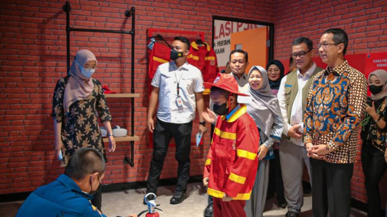 Penjabat Gubernur DKI Heru Budi Hartono (kanan) menyaksikan simulasi peserta cilik menangani kebakaran di Ruang Komunikasi, Informasi dan Edukasi (KIE) Kebencanaan Dinas Gulkarmat DKI Jakarta, Kamis (29/12/2022). ANTARA/HO-Pemprov DKI