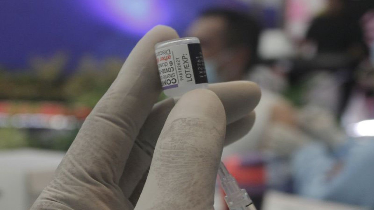 Petugas vaksin mengambil cairan vaksin dari dalam botol vaksin jenis Pfizer saat pelaksanaan vaksinasi COVID-19 tahap keempat atau vaksin booster kedua di kantor Bank Indonesia Perwakilan NTT di Kupang, NTT, Jumat(24/2/2023).ANTARA FOTO/Kornelis Kaha