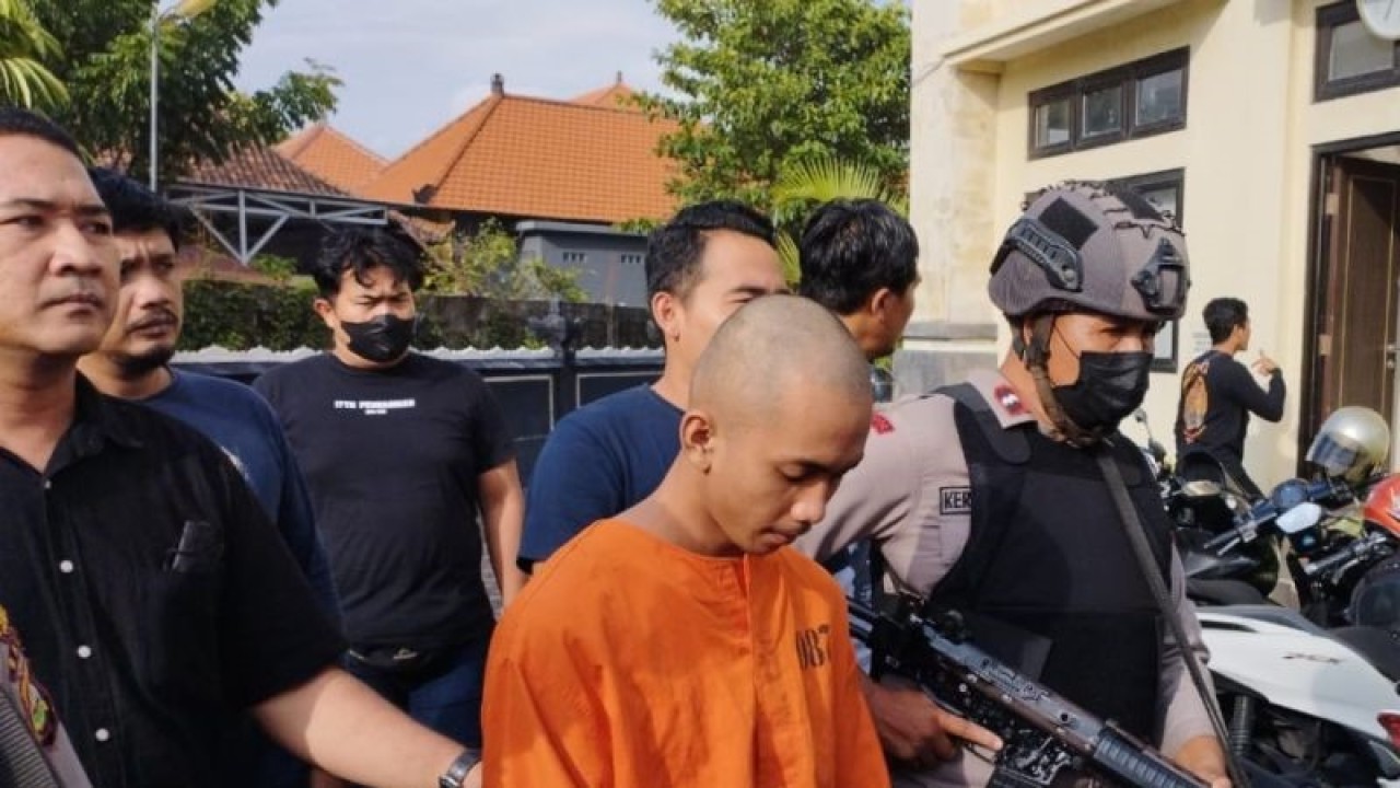 Polisi menggiring tersangka IKJ (18) yang diduga membunuh korban NMDS (16) yang masih berstatus sebagai pelajar SMK di Denpasar, Bali, Rabu (8/2/2023). ANTARA/Rolandus Nampu