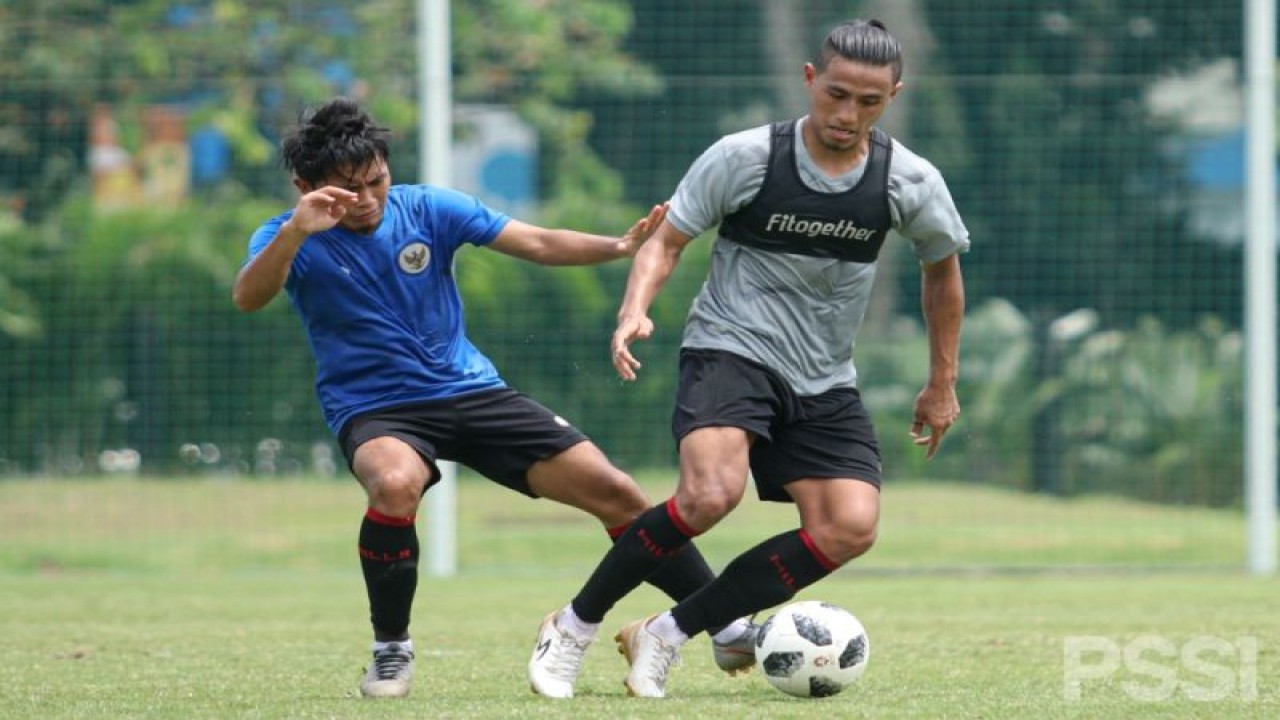 Pemain tim abu-abu Hanif Sjahbandi (kanan) berebut bola dengan lawannya dari tim biru dalam laga internal tim nasional U-22 Indonesia di Lapangan D Gelora Bung Karno, Jakarta, Sabtu (27/2/2021). Laga yang menjadi bagian dari pemusatan latihan persiapan SEA Games 2021 itu berakhir dengan skor 4-4. (ANTARA/HO/PSSI)