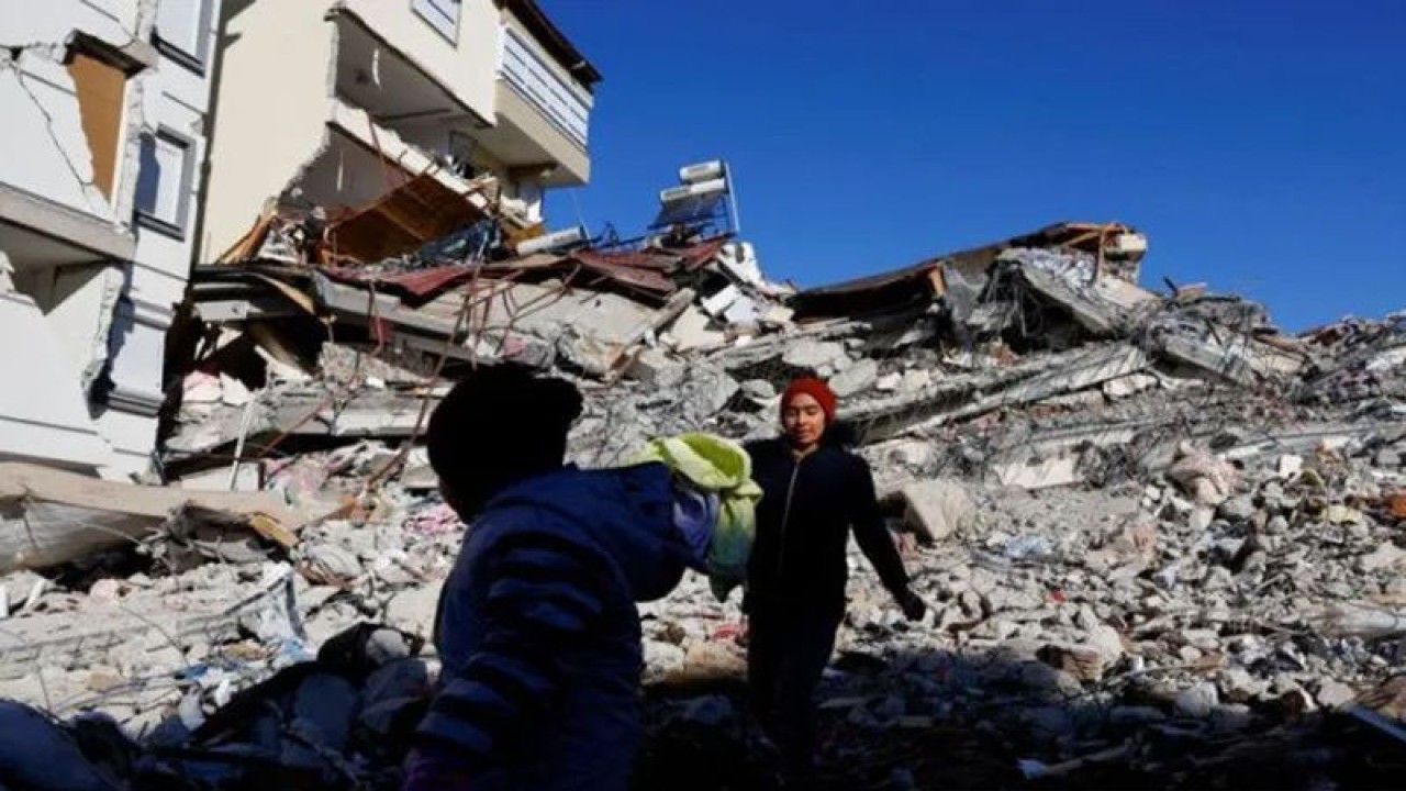 Arsip Foto - Anak-anak berdiri di tengah puing-puing bangunan yang runtuh, pascagempa di Pazarcik, Turki, (9/2/2023). (ANTARA FOTO/REUTERS/Suhaib Salem)