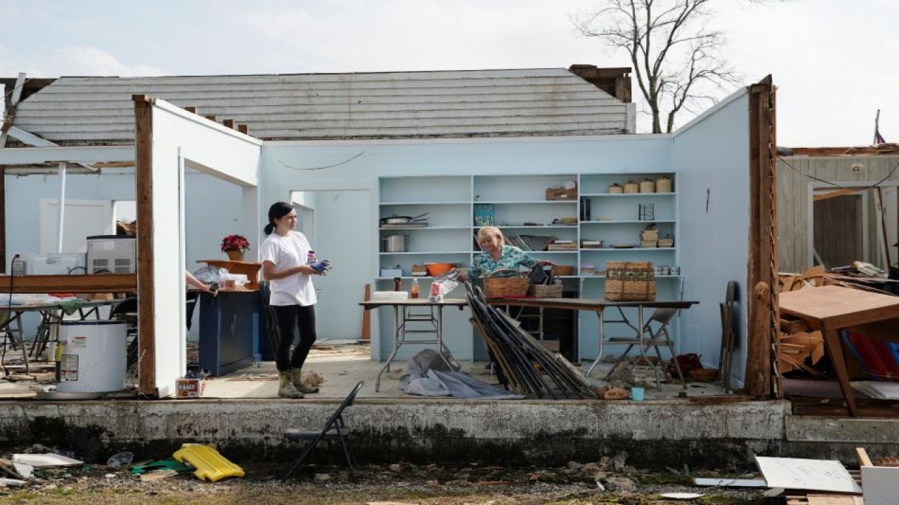 Arsip - Kathy Poss (kanan) menyelamatkan barang-barang dari Gereja Metodis Ragan Chapel United sehari setelah serangkaian tornado menyebabkan beberapa kematian di Ohatchee, Alabama, AS, Jumat (26/3/2021). ANTARA FOTO/REUTERS/Elijah Nouvelage/RWA/sa. (REUTERS/ELIJAH NOUVELAGE)
