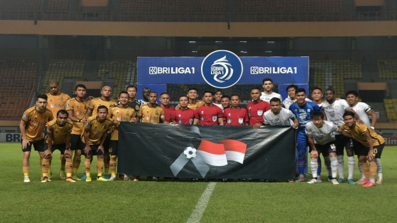 Sejumlah pesepak bola Bhayangkara FC dan Rans Nusantara FC foto dengan membentangkan banner duka cita atas gagalnya Indonesia menjadi tuan rumah Piala Dunia U-20, saat lanjutan Liga 1 di Stadion Wibawa Mukti, Cikarang, Kabupaten Bekasi, Jawa Barat, Kamis (30/3/2023). ANTARA FOTO/ Fakhri Hermansyah/rwa. (ANTARA FOTO/Fakhri Hermansyah)