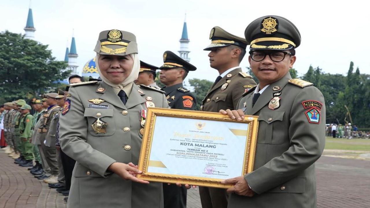 Gubernur Jawa Timur Khofifah Indar Parawansa (kiri) menyerahkan penghargaan Sijalinmajataru kepada Wali Kota Malang Sutiaji, di Alun-Alun Kabupaten Tuban, Jawa Timur, Rabu (8/3/2023). (ANTARA/HO-Humas Pemkot Malang)