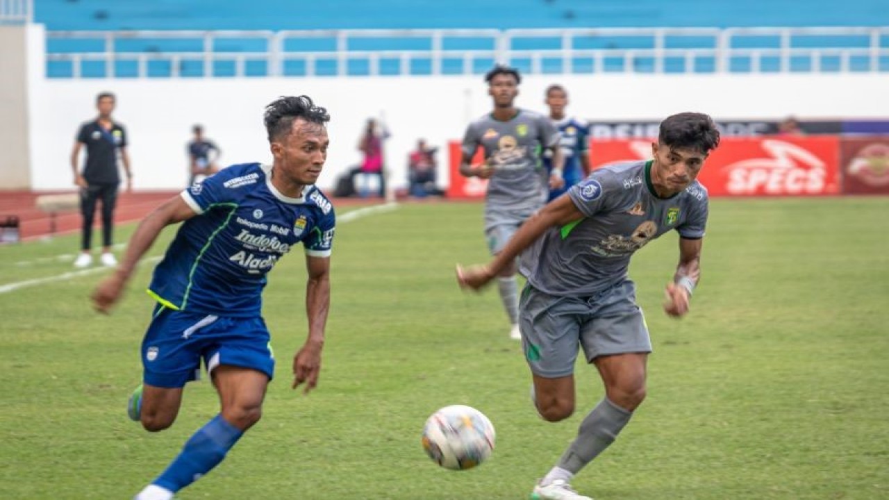 Pesepak bola Persib Bandung Robi Darwis (kiri) berupaya melewati hadangan pesepak bola Persebaya Riswan Lauhin (kanan) dalam pertandingan lanjutan BRI Liga 1 di Stadion Jatidiri, Semarang, Jawa Tengah, Sabtu (10/12/2022). Persib Bandung mengalahkan Persebaya dengan skor 2-1. ANTARA FOTO/Aji Styawan/wsj. (ANTARA FOTO/AJI STYAWAN)