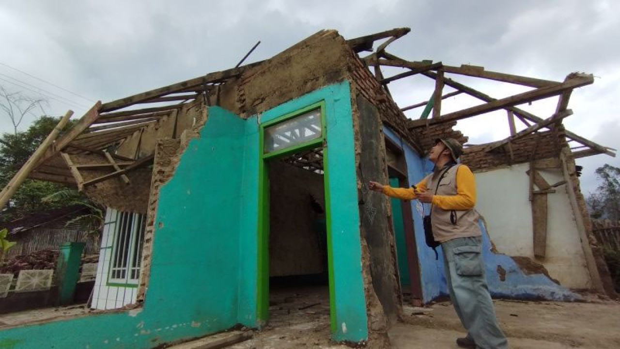 Petugas PVMBG memeriksa kondisi rumah yang rusak akibat guncangan gempa di Desa Cisarua, Kecamatan Samarang, Kabupaten Garut, Jawa Barat. (FOTO ANTARA/Feri Purnama/dok.)