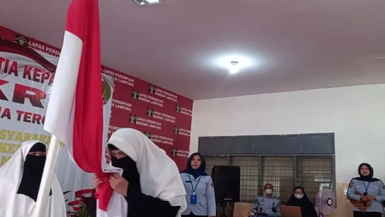 Tiga narapidana saat mengucapkan ikrar setia kepada NKRI dan mencium Bendera Merah Putih saat pengucapan ikrar NKRI di Lapas Perempuan. (ANTARA/HO-Damiri)