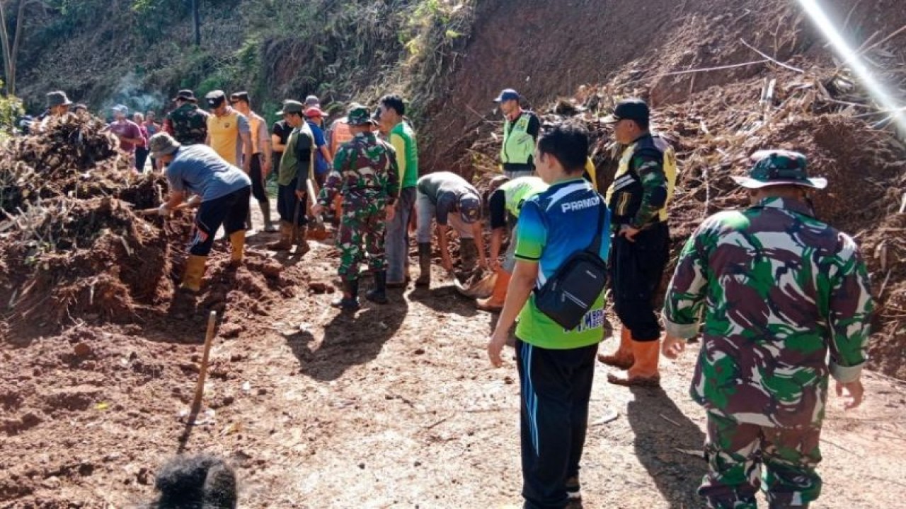 Petugas BPBD Batang bersama TNI dan masyarakat menyingkirkan sisa material tanah longsor di jalan penghubung Kecamatan Limpung-Bawang, Jumat (3/3/2023). (ANTARA/HO-Humas Kabupaten Batang)