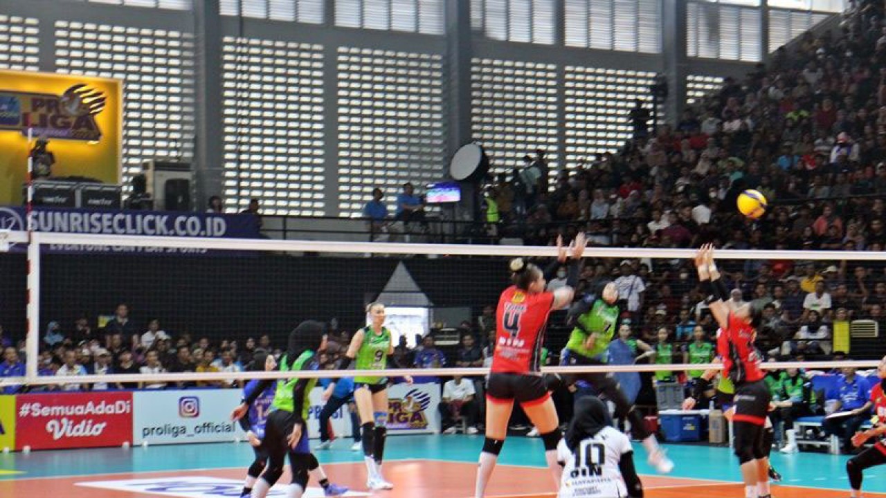 Pebola voli putri Pertamina Fastron Tasya Nur (kostum hijau-hitam) saat melepas smas dan diblok oleh dua pemain Jakarta BIN (kostum merah hitam) dalam pertandingan PLN Mobile Proliga 2023 putaran final four seri tiga pamungkas , di Gor Sritex Arena Solo, Jawa Tengah, Jumat (10/3/2023) petang. ANTARA/Bambang Dwi Marwoto.