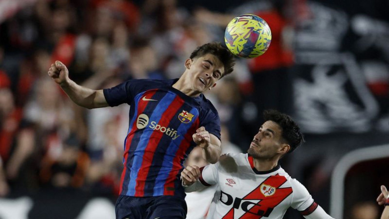 Pesepak bola Barcelona Gavi menyundul bola dibayangi pemain Rayo Vallecano Oscar Valentin dalam laga lanjutan Liga Spanyol di Campo de Futbol de Vallecas, Madrid, Spanyol, Rabu (26/4/2023). Vallecano mengalahkan Barca dengan skor 2-1. ANTARA FOTO/REUTERS/Juan Medina/foc.