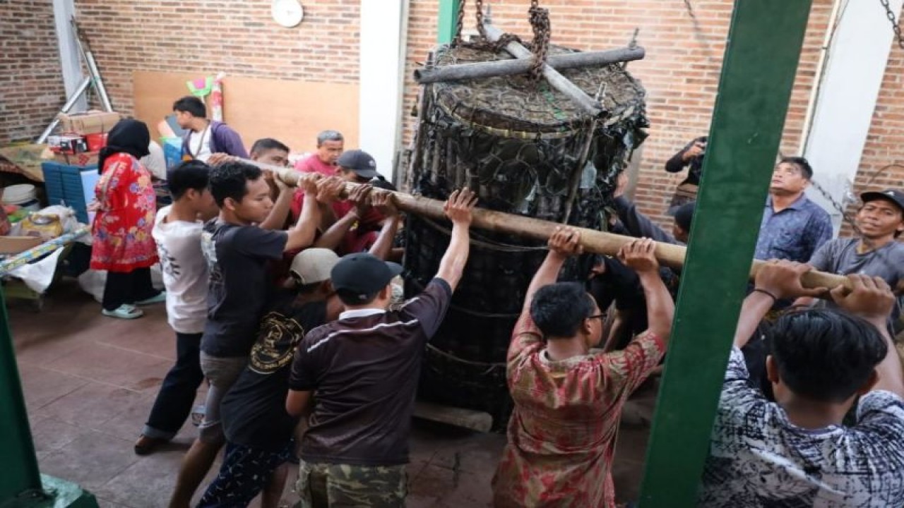Sejumlah pemuda Kelurahan Krapyak Kota Pekalongan sedang melakukan peletakan lopis raksasa yang dipersiapkan pada acara tradisi Syawalan, Kamis (27/4/2023). (ANTARA/HO-Humas Pemkot Pekalongan)