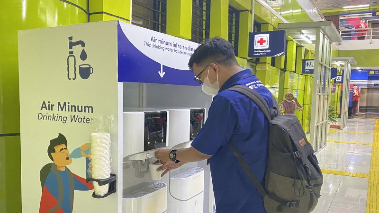 Seorang penumpang kereta api mencoba fasilitas water station di Stasiun Gambir, Jakarta, Rabu (19/4/2023). (ANTARA/AstridFaidlatulHabibah)