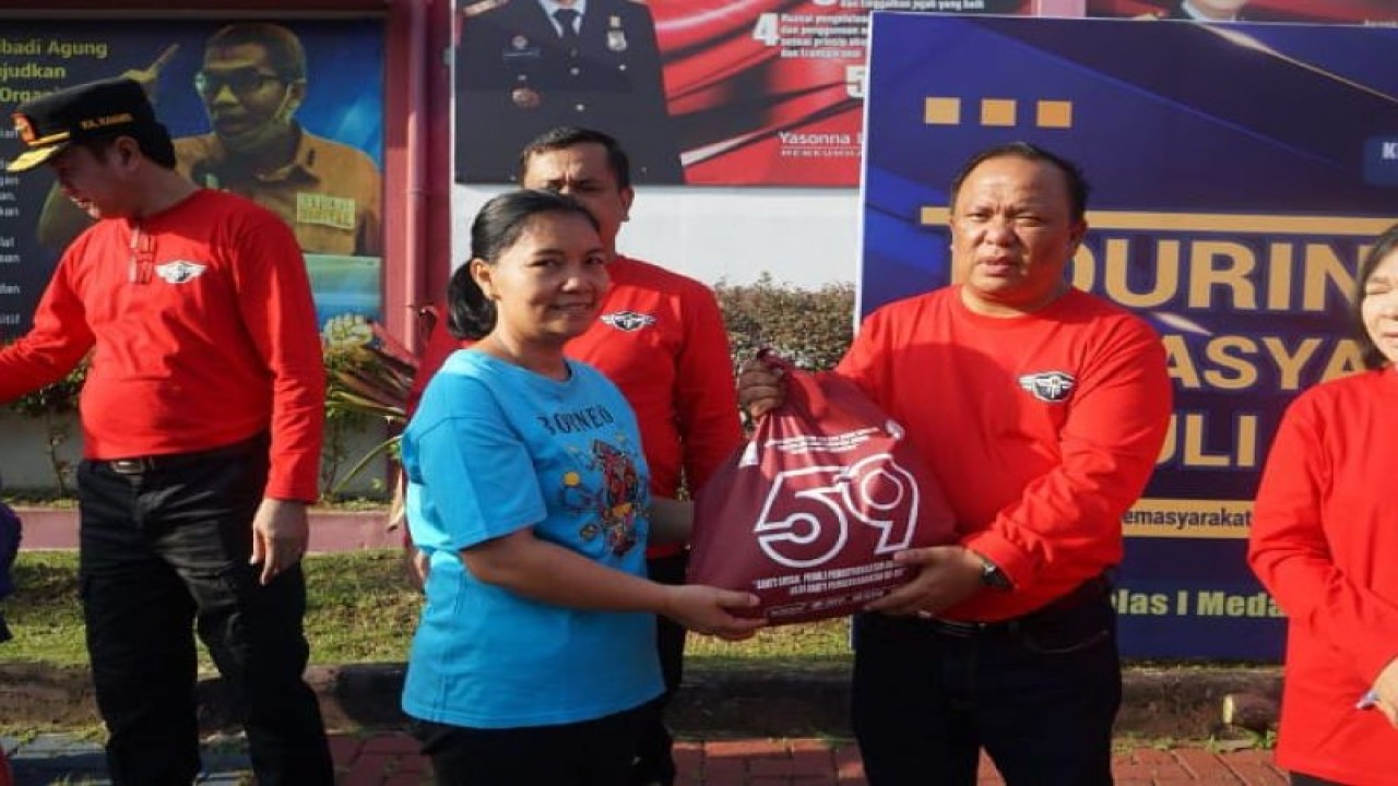 Kalapas Kelas I Medan, Maju Amintas Siburian memberikan beras kepada warga setempat. (ANTARA/HO)