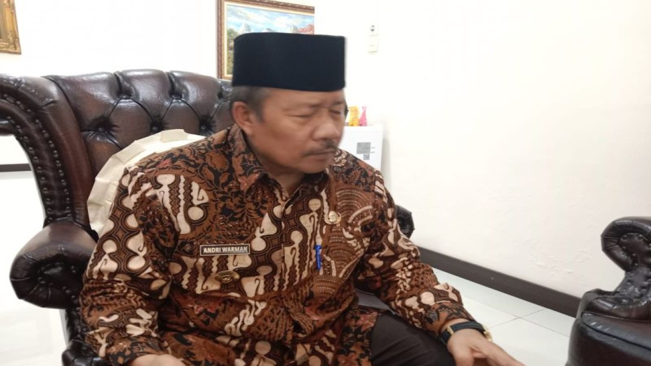 Bupati Agam Andri Warman sedang memegang produk UMKM.