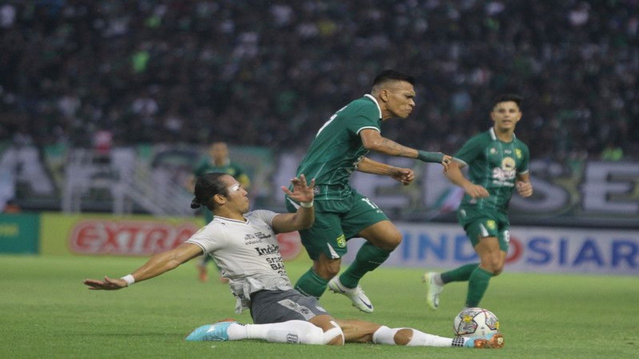 Pesepak bola Persebaya Ferdinan Sinaga (kedua kiri) berusaha melewati pesepak bola Bali United Ryuji Utomo (kiri) saat pertandingan uji coba di Stadion Gelora Bung Tomo, Surabaya, Jawa Timur, Minggu (28/5/2023). Pada pertandingan uji coba tersebut Persebaya mengalahkan Bali United dengan skor akhir 3-1. ANTARA FOTO/Moch Asim