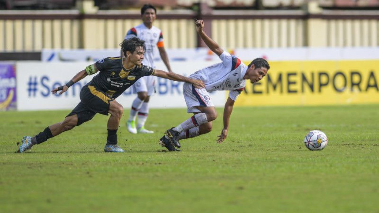 Pesepak bola Dewa United Rangga Muslim (kiri) berupaya menghambat gerak pesepak bola Arema FC Malang Evan Dimas (kanan) pada pertandingan Liga 1 di Stadion PTIK, Jakarta, Jumat (10/3/2023). Pertandingan berakhir dengan skor imbang 0-0. ANTARA FOTO/Galih Pradipta/tom. (ANTARA FOTO/GALIH PRADIPTA)