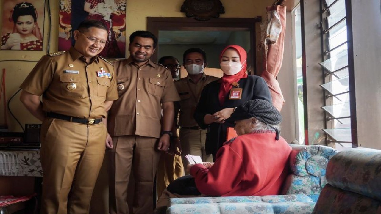 Penjabat Wali Kota Batu Aries Agung Paewai (kiri) menemui warga lanjut usia penerima BLT Mitigasi Inflasi tahap dua dan insentif untuk lansia di Kota Batu, Jawa Timur, Senin (8/5/2023). (ANTARA/HO-Humas Pemkot Batu)