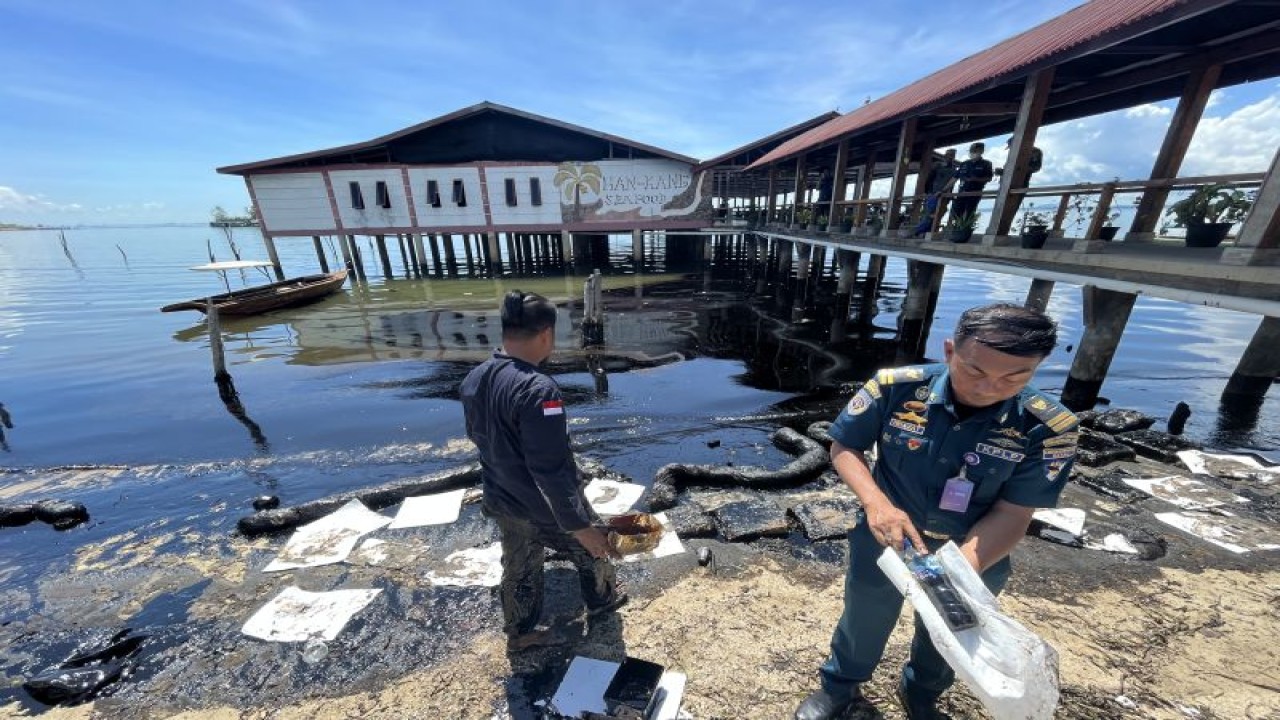 Petugas membersihkan polutan yang mencemari air Pantai Kampung Melayu di Kota Batam, Provinsi Kepulauan Riau, Rabu (3/5/2023). (ANTARA/Jessica)