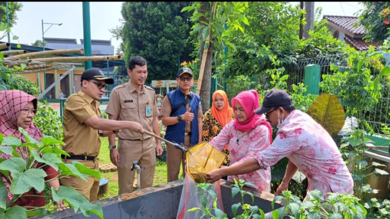 Sekertaris Kelurahan (Sekkel) Srengseng, Rizky Raya Dwiputra bersama Satpel KPKP Kecamatan Kembangan dan RPTRA Edelweis sedang memanen lele pada Senin (15/5/2023). Antara/HO-Pemkot Jakbar