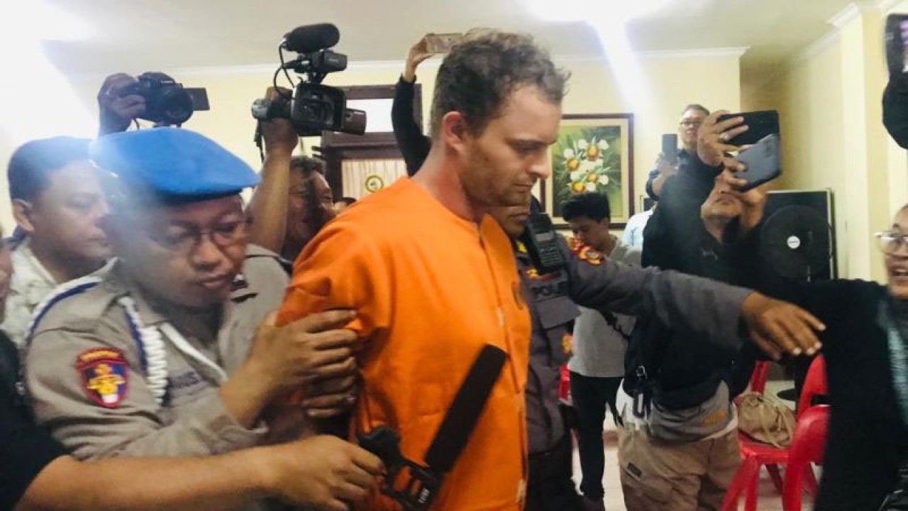 Polisi menggiring tersangka DDI (29) pelaku penganiayaan saat menggelar konferensi pers di Polsek Kuta, Kabupaten Badung, Bali, Selasa (6/6/2023). ANTARA/Rolandus Nampu.