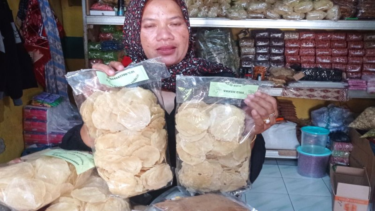 Awa (45), seorang pemilik Toko Najwa yang menjual aneka makanan tradisional di Jalan Sunan Bonang Rangkasbitung, Kabupaten Lebak, Banten selama liburan panjang pada pekan kemarin, kewalahan melayani permintaan kerupuk emping melinjo untuk dijadikan buah tangan atau oleh-oleh. ANTARA/Mansur