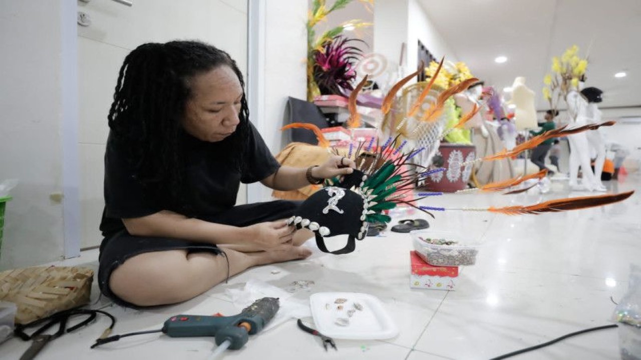 Salah seorang anak muda merancang dan memproduksi busana yang akan ditampilkan dalam acara Papua Street Carnival.  (ANTARA/HO-PYCH)