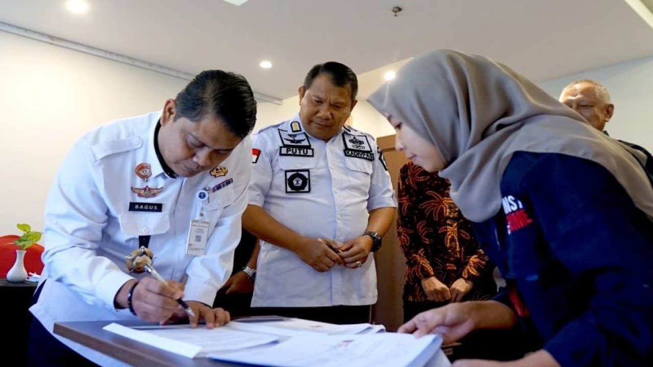 Kepala Divisi Pemasyarakatan Kanwil Kemenkumham Provinsi Gorontalo Bagus Kurniawan (kiri) disaksikan Kepala Divisi Pemasyarakatan Kanwil Kementerian Hukum dan HAM Sulawesi Utara I Putu Murdiana (tengah) menandatangani nota kesepahaman di Kota Gorontalo, Gorontalo, Rabu (12/7/2023). ANTARA/Adiwinata Solihin