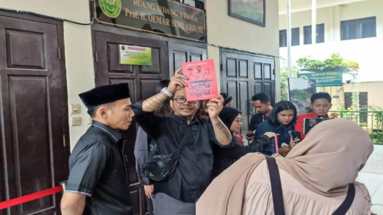 Ayah David Ozora, Jonathan Latumahina menunjukkan buku 'rapor merah' yang diberikan ke majelis hakim di Pengadilan Negeri Jakarta Selatan, Selasa (29/8/2023). ANTARA/ Ilham Kausar