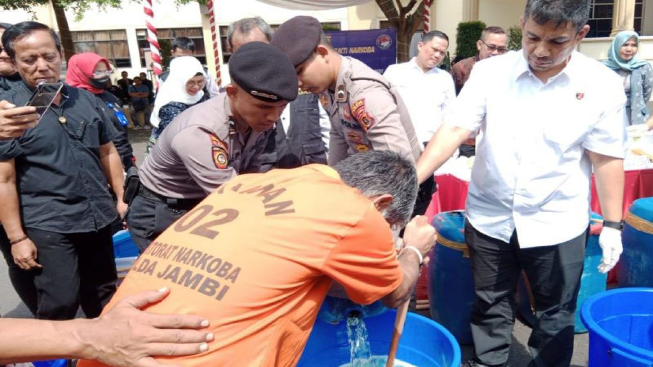 Seorang tersangka yang menjadi kurir sabu cair ikut memusnahkan barang bukti di Polda Jambi, Kamis (3/8/2023) (ANTARA/Tuyani)