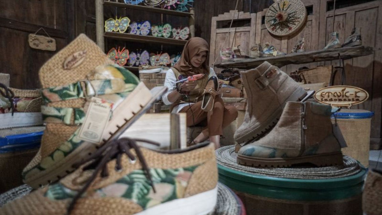 Perajin menyelesaikan kerajinan sepatu berbahan limbah karung goni di workshop Etnic-K, Mojosongo, Jebres, Solo, Jawa Tengah, Rabu (9/8/2023). ANTARA FOTO/Mohammad Ayudha/aww.