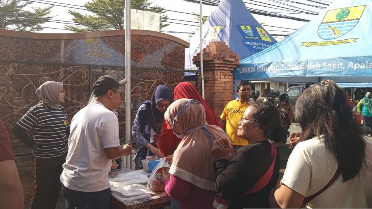 Sejumlah warga sedang mengantre untuk membeli beras murah dari Pemkot Cirebon di Kota Cirebon, Jawa Barat. (ANTARA/Fathnur Rohman)